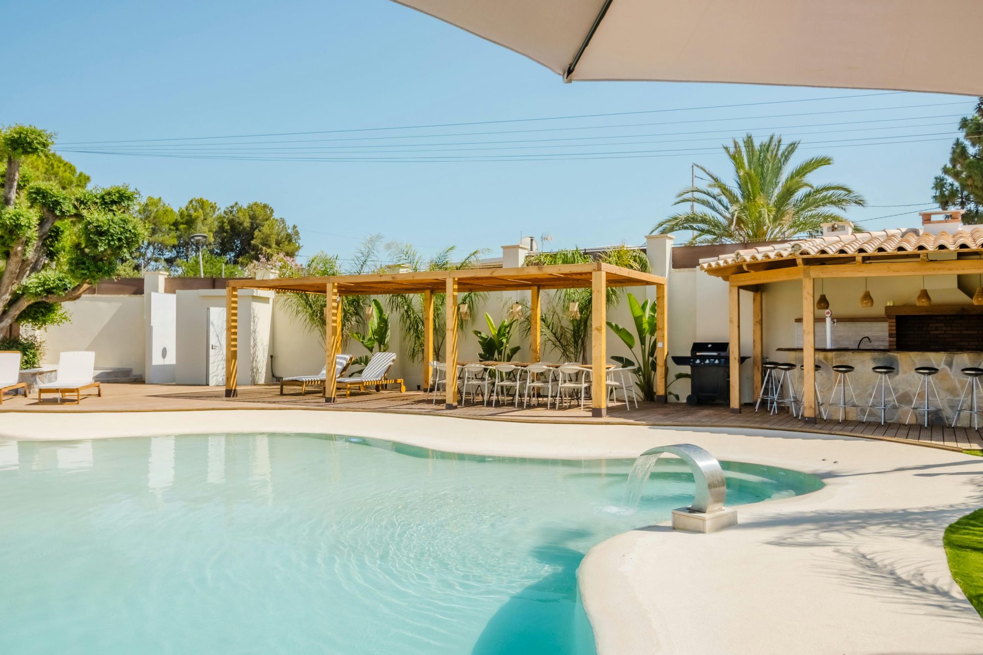 Villa moderna con piscina en España, que destaca por su elegante arquitectura y su zona de comedor al aire libre.